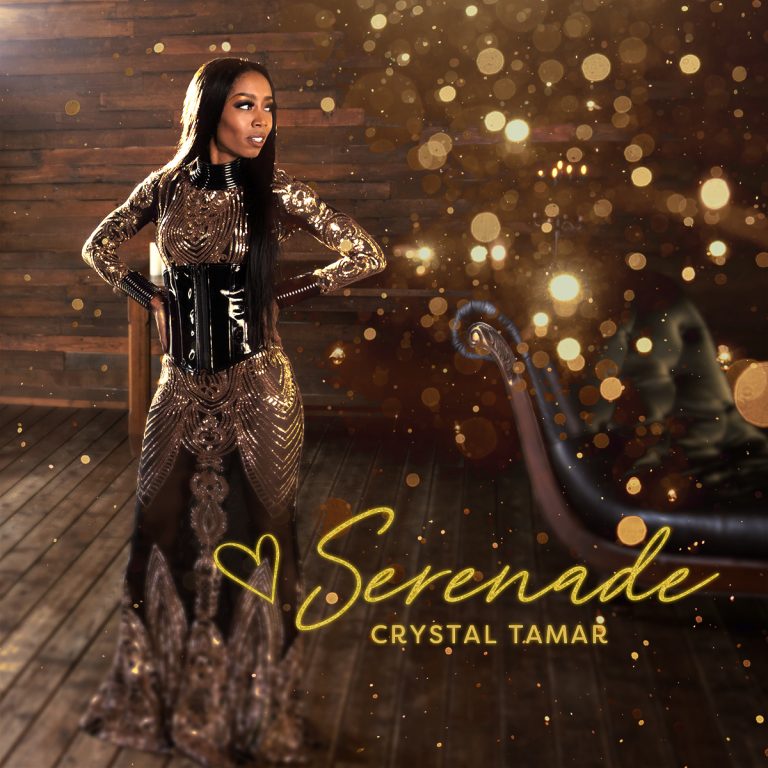 Album cover for Serenade, by Crystal Tamar. Crystal Tamar stands in front of a wood wall, wearing a gold dress and black corset as she stands with her hands on her hips. Crystal is smiling, looking over to her left.